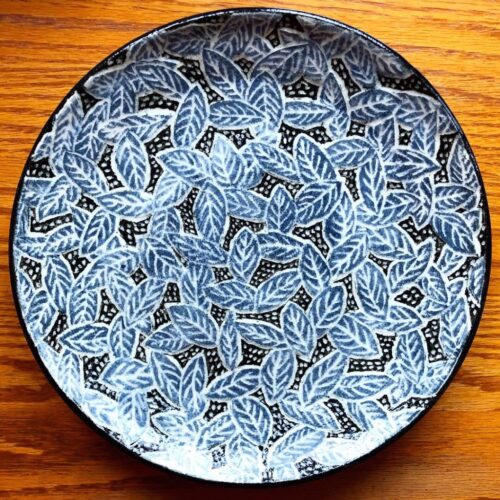 Wheel Thrown Plate with Gray Leaves on a Black Background